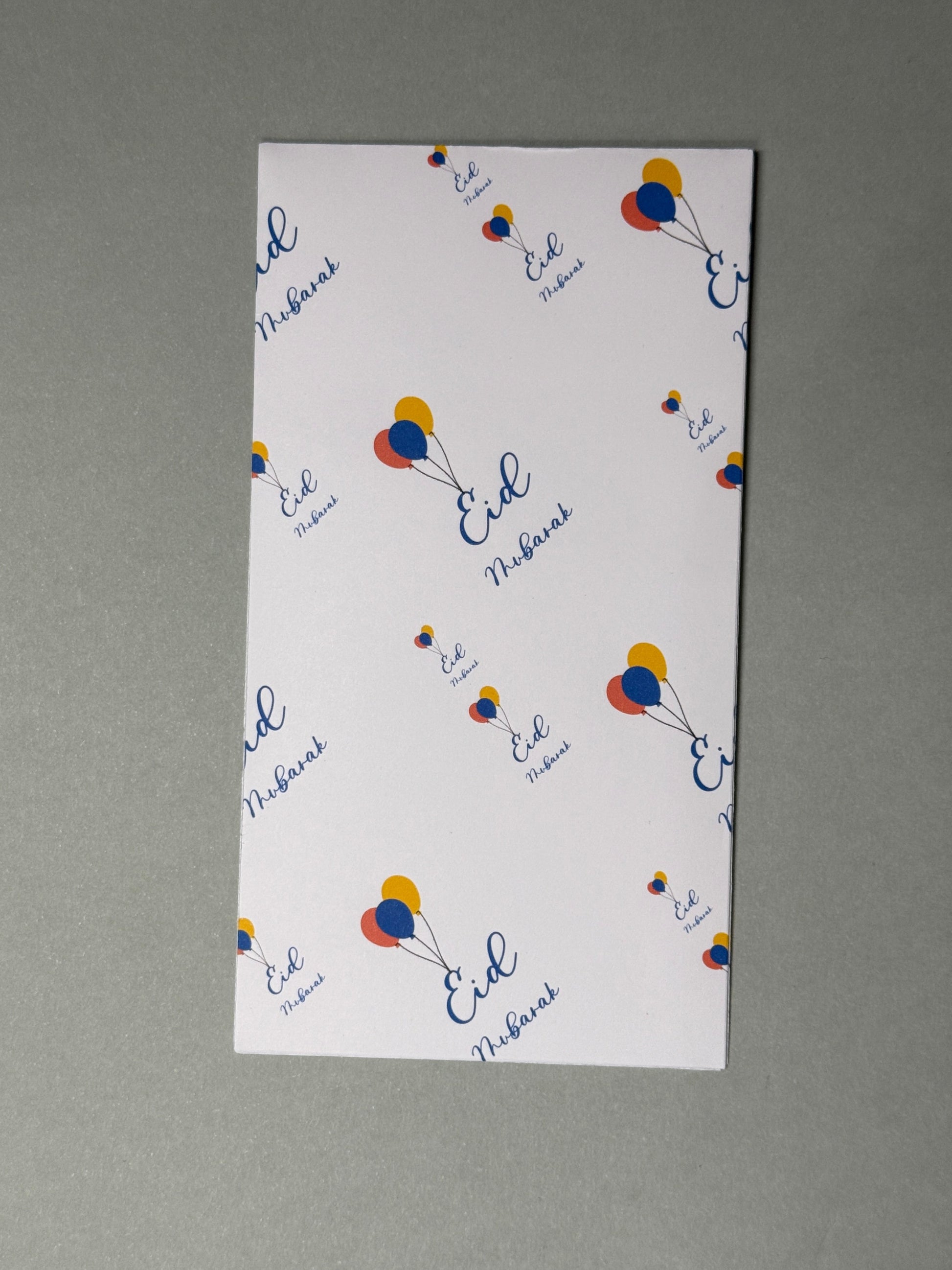 Eid Mubarak money envelope with tri colored balloons connected to the E