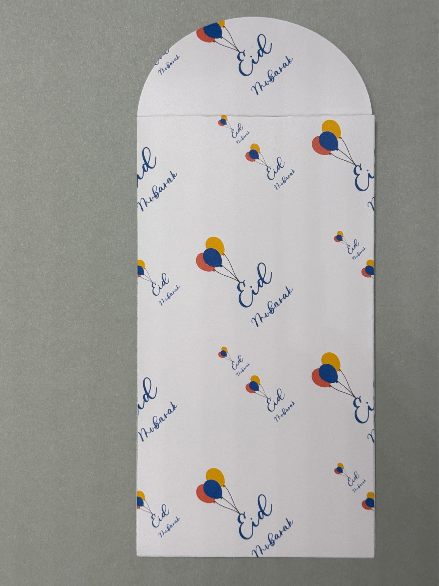Eid Mubarak money envelope with tri colored balloons connected to the E